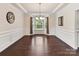 Formal dining room with hardwood floors, wainscoting, and a chandelier is ideal for entertaining at 17012 Alydar Commons Ln, Charlotte, NC 28278