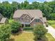Stunning home featuring a brick and stone facade, manicured landscaping, and a covered front porch at 17012 Alydar Commons Ln, Charlotte, NC 28278