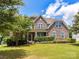 Beautiful stone facade home with a well-manicured lawn and mature landscaping in a desirable neighborhood at 17012 Alydar Commons Ln, Charlotte, NC 28278