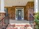 Charming covered front porch with brick columns and iron railings welcomes you to this beautiful home at 17012 Alydar Commons Ln, Charlotte, NC 28278