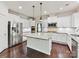 Bright kitchen featuring granite countertops, white cabinetry, stainless steel appliances, and a center island at 17012 Alydar Commons Ln, Charlotte, NC 28278