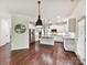 Spacious kitchen with white cabinetry, stainless steel appliances, granite countertops, and hardwood flooring at 17012 Alydar Commons Ln, Charlotte, NC 28278