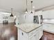 Kitchen with white cabinets, stainless appliances, granite countertops and kitchen island with pendant lighting at 17012 Alydar Commons Ln, Charlotte, NC 28278