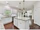 Kitchen featuring granite countertops, white cabinetry, stainless steel appliances, and an island with seating at 17012 Alydar Commons Ln, Charlotte, NC 28278