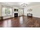 Bright living room featuring a fireplace, hardwood floors, and modern chandelier at 17012 Alydar Commons Ln, Charlotte, NC 28278
