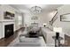 Inviting living room featuring a fireplace, hardwood floors, neutral decor, and ample seating at 17012 Alydar Commons Ln, Charlotte, NC 28278