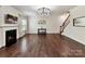 Bright living room featuring hardwood floors, fireplace, ample natural light, and staircase access at 17012 Alydar Commons Ln, Charlotte, NC 28278