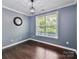 Well-lit office space featuring hardwood floors, neutral paint, and a large window for natural light at 17012 Alydar Commons Ln, Charlotte, NC 28278