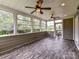 Enclosed sunroom featuring wood-look flooring and picturesque backyard views at 17012 Alydar Commons Ln, Charlotte, NC 28278
