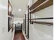 Walk-in wine room boasts a custom rack, shelving, and display area with hardwood flooring throughout at 17012 Alydar Commons Ln, Charlotte, NC 28278