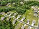 Stunning aerial view of a neighborhood featuring well-maintained homes, lush greenery, and a serene lake at 17733 Burnt Hickory Dr, Charlotte, NC 28278