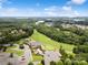 An aerial view showing the neighborhood's proximity to a golf course, clubhouse, and parking lot at 17733 Burnt Hickory Dr, Charlotte, NC 28278