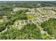 Aerial view of a charming neighborhood nestled amongst lush trees, showcasing serene water views and well-maintained homes at 17733 Burnt Hickory Dr, Charlotte, NC 28278