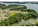 Aerial view of a lakeside community featuring beautiful homes nestled among lush trees and serene water views at 17733 Burnt Hickory Dr, Charlotte, NC 28278