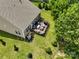 Aerial view of the backyard showcasing a spacious wooden deck with outdoor furniture, lush lawn, and air conditioning unit at 17733 Burnt Hickory Dr, Charlotte, NC 28278