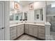 Bright bathroom featuring a double vanity, framed mirrors and contemporary decorative vases at 17733 Burnt Hickory Dr, Charlotte, NC 28278