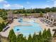 An aerial view of the community pool with a large swimming area, waterslide, and lounge chairs at 17733 Burnt Hickory Dr, Charlotte, NC 28278