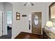 Inviting entryway featuring a wooden front door with decorative glass, hardwood floors, and neutral wall color at 17733 Burnt Hickory Dr, Charlotte, NC 28278