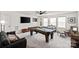 Spacious game room with a pool table, comfortable seating, and a flat-screen TV for entertainment at 17733 Burnt Hickory Dr, Charlotte, NC 28278