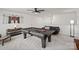 Well-lit game room featuring a pool table, sofa, and stylish decor for leisure and entertainment at 17733 Burnt Hickory Dr, Charlotte, NC 28278