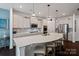Modern kitchen features an expansive island, stainless steel appliances, and pendant lighting at 17733 Burnt Hickory Dr, Charlotte, NC 28278