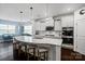 Bright kitchen features a large island with seating, stainless steel appliances, and white cabinetry at 17733 Burnt Hickory Dr, Charlotte, NC 28278