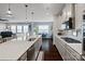 Open concept kitchen features a large island with sink and stainless steel appliances at 17733 Burnt Hickory Dr, Charlotte, NC 28278