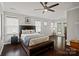 Bright main bedroom features hardwood floors, a ceiling fan, and ample natural light at 17733 Burnt Hickory Dr, Charlotte, NC 28278