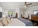 Main bedroom features a ceiling fan, hardwood floors, and access to an outdoor patio at 17733 Burnt Hickory Dr, Charlotte, NC 28278