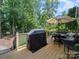 Outdoor grill and an inviting deck, ideal for outdoor cooking and relaxation with a shaded dining area at 1808 Mill Chase Ln, Waxhaw, NC 28173