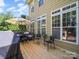 Spacious back deck features outdoor dining, comfortable seating, and a large sun umbrella for relaxation and entertainment at 1808 Mill Chase Ln, Waxhaw, NC 28173