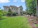 Expansive backyard with lush lawn, patio, and deck perfect for outdoor entertaining and relaxation at 1808 Mill Chase Ln, Waxhaw, NC 28173