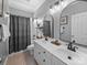 Bathroom with dual sinks, large mirrors, updated fixtures, and a shower/tub combo at 1808 Mill Chase Ln, Waxhaw, NC 28173