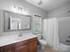 Well-lit bathroom with vanity, framed mirror, toilet, and shower/tub combination at 1808 Mill Chase Ln, Waxhaw, NC 28173
