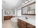 Bright and spacious bathroom with double vanity, tub, tile floors, and large mirror at 1808 Mill Chase Ln, Waxhaw, NC 28173