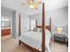 Comfortable bedroom boasts a four poster bed, ceiling fan, and ensuite bathroom access at 1808 Mill Chase Ln, Waxhaw, NC 28173
