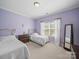 Bedroom with twin beds and a window, neutral color palette for relaxation at 1808 Mill Chase Ln, Waxhaw, NC 28173