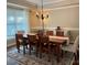 Traditional dining room with wood table, chandelier, and patterned rug creates a cozy atmosphere for gatherings at 1808 Mill Chase Ln, Waxhaw, NC 28173
