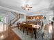 Open concept dining room with staircase leading to the second floor and adjacent kitchen with a large island at 1808 Mill Chase Ln, Waxhaw, NC 28173