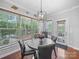 Cozy dining area with wood floors, windows, and a door leading to the exterior at 1808 Mill Chase Ln, Waxhaw, NC 28173