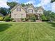 Charming two-story home with manicured lawn and stone accents, captured on a bright day at 1808 Mill Chase Ln, Waxhaw, NC 28173