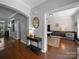 Foyer with hardwood floors and an arched doorway leading to a study, showcasing a blend of modern and classic design at 1808 Mill Chase Ln, Waxhaw, NC 28173