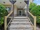 Inviting front porch with stone steps, dark wood posts, and a view of the home's facade at 1808 Mill Chase Ln, Waxhaw, NC 28173
