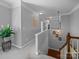 Upstairs hallway featuring carpet, crown molding, and a staircase leading to the first floor at 1808 Mill Chase Ln, Waxhaw, NC 28173