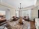 Bright living room with leather furnishings, a stylish area rug, and large windows offering scenic views at 1808 Mill Chase Ln, Waxhaw, NC 28173