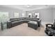 Bright living room featuring a large sectional sofa, multiple windows and neutral color palette at 1808 Mill Chase Ln, Waxhaw, NC 28173