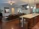 Open concept layout with a kitchen island flowing into the living room and staircase at 1808 Mill Chase Ln, Waxhaw, NC 28173