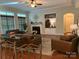 Comfortable living room with a fireplace, built-in shelving, and ample seating creates a warm and inviting space at 1808 Mill Chase Ln, Waxhaw, NC 28173