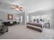 Spacious main bedroom offers a comfortable bed and seating area at 1808 Mill Chase Ln, Waxhaw, NC 28173