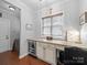 Office space featuring custom cabinets, granite countertops, built-in wine cooler and window with blinds at 1808 Mill Chase Ln, Waxhaw, NC 28173